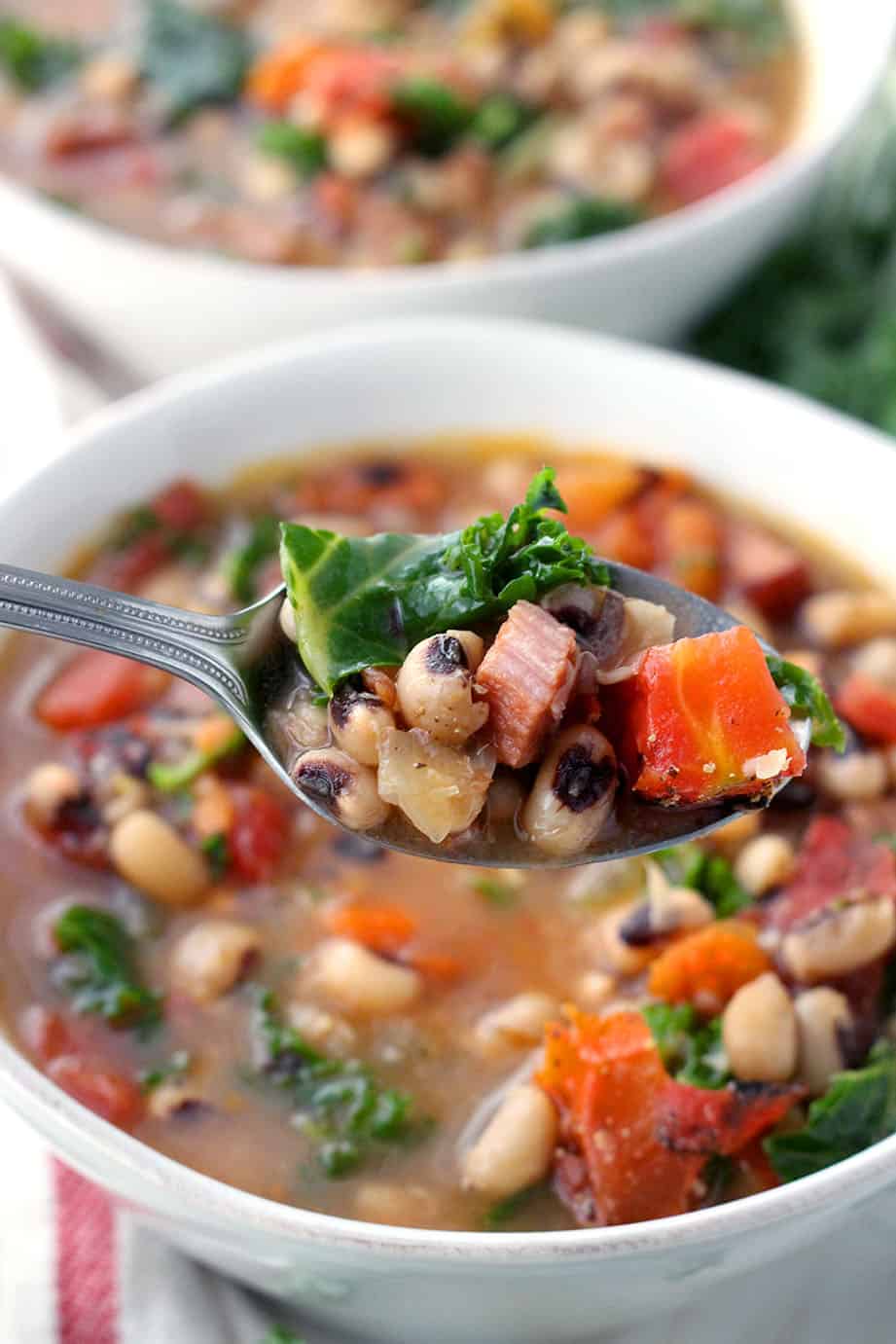 This Instant Pot Black Eyed Pea Soup is an easy and fast way to serve traditional black eyed peas and greens on New Year's day for good luck and good health! Packed with veggies, healthy pulses, freezable, and gluten/dairy free. #blackeyedpeas #glutenfreesoup #instantpot #pressurecooker #freezermeals #newyearsrecipes