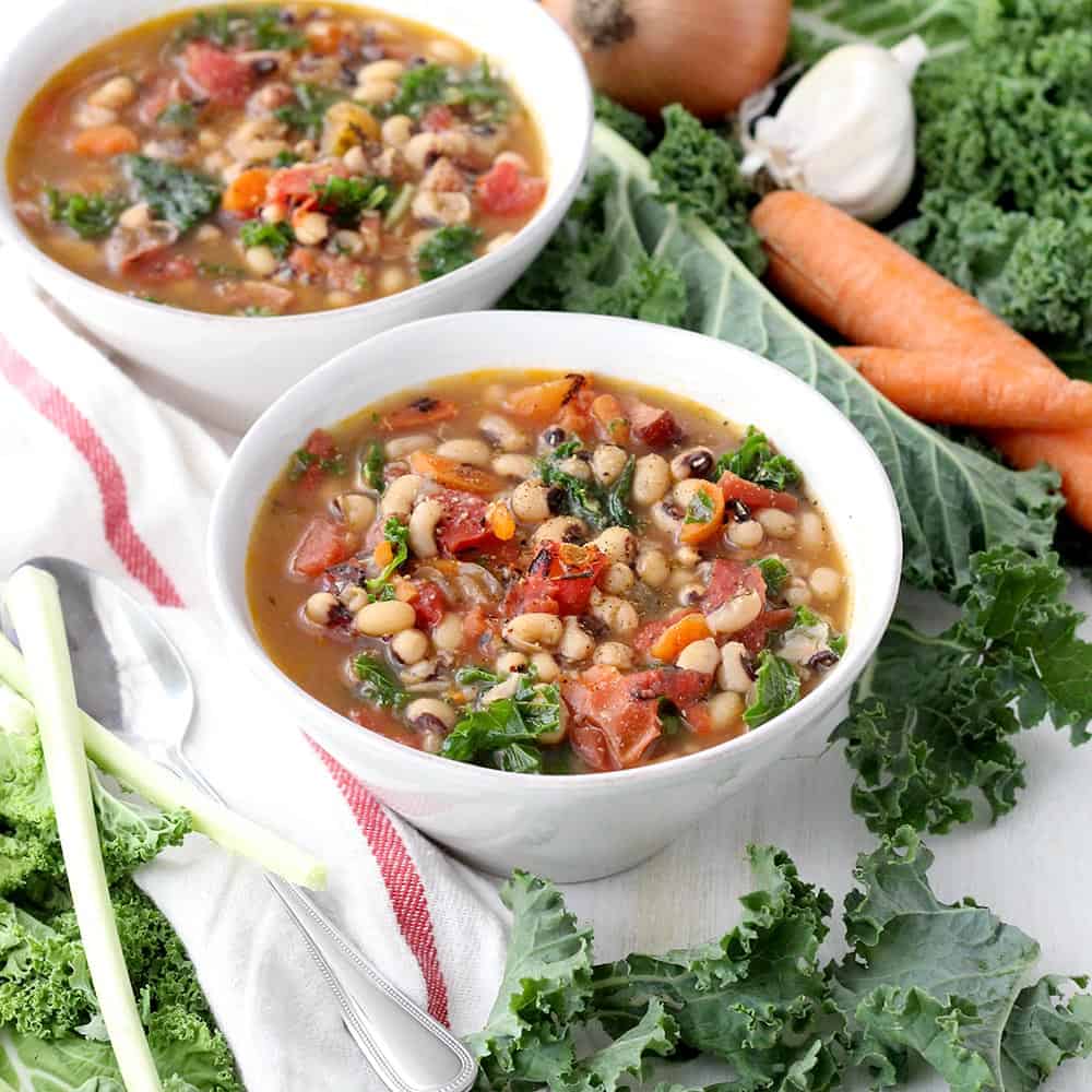 This Instant Pot Black Eyed Pea Soup is an easy and fast way to serve traditional black eyed peas and greens on New Year's day for good luck and good health! Packed with veggies, healthy pulses, freezable, and gluten/dairy free. #blackeyedpeas #glutenfreesoup #instantpot #pressurecooker #freezermeals #newyearsrecipes