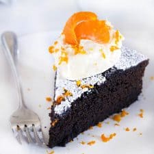 This spicy gingerbread cake with orange mascarpone cream is packed with fresh ginger flavor and all the holiday spices you love! It's not too sweet and has very little refined sugar, and pairs perfectly with the light, fluffy whipped cream made with mascarpone cheese and fresh orange zest and juice. It's the perfect holiday dessert! #Gingerbread #Oranges #WhippedCream #HolidayBaking #GingerbreadCake #LowSugar