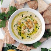 This Quick and Easy Classic Hummus recipe is a fast way to get super smooth, creamy hummus without using dry beans or removing the skins! It's high in fiber, protein, and healthy fats, and it makes a wonderful snack on pita bread or spread on sandwiches. #HummusRecipe #ClassicHummus #HealthySnackRecipes #ChickpeaRecipes #VeganRecipes #GlutenFreeSnacks