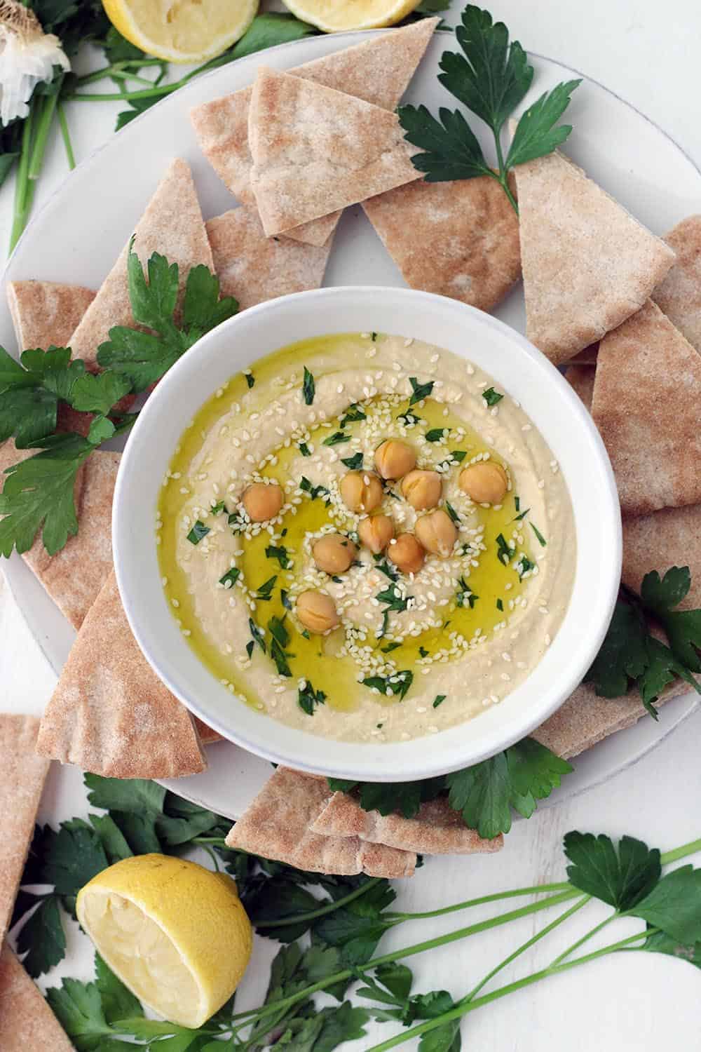 This Quick and Easy Classic Hummus recipe is a fast way to get super smooth, creamy hummus without using dry beans or removing the skins! It's high in fiber, protein, and healthy fats, and it makes a wonderful snack on pita bread or spread on sandwiches. #HummusRecipe #ClassicHummus #HealthySnackRecipes #ChickpeaRecipes #VeganRecipes #GlutenFreeSnacks