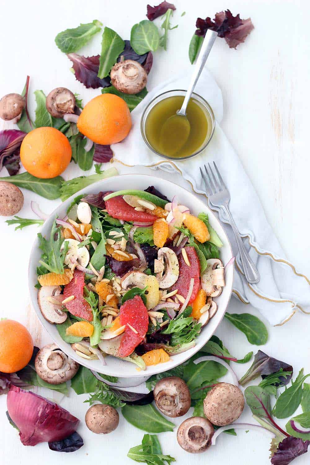 This delicious Winter Citrus Salad with Red Wine Vinaigrette is packed with seasonal Mandarin oranges and grapefruit. It's tossed with thinly sliced mushrooms, toasted almonds, and a versatile red wine vinaigrette, and is a great recipe for meal prepping!