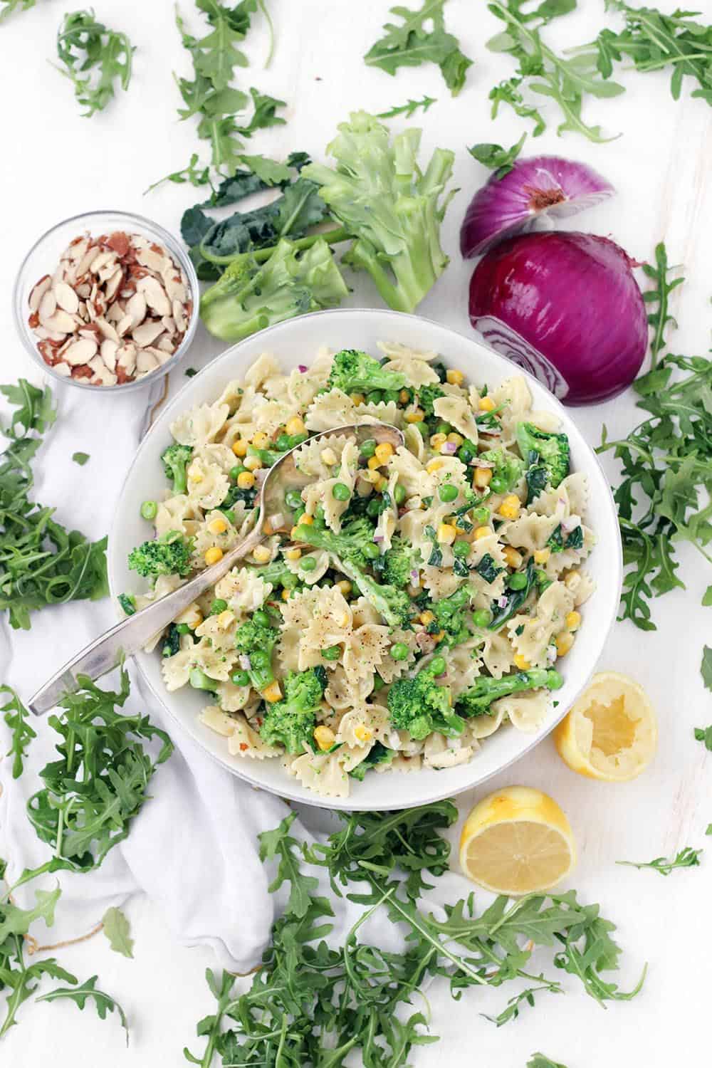 This creamy lemony vegetable pasta salad recipe is a cinch to make- the vegetables boil directly in the pasta water for less effort and clean up. Tossed in a light lemon garlic mayo and olive oil dressing, this is the perfect vegetarian make-ahead side or light meal.