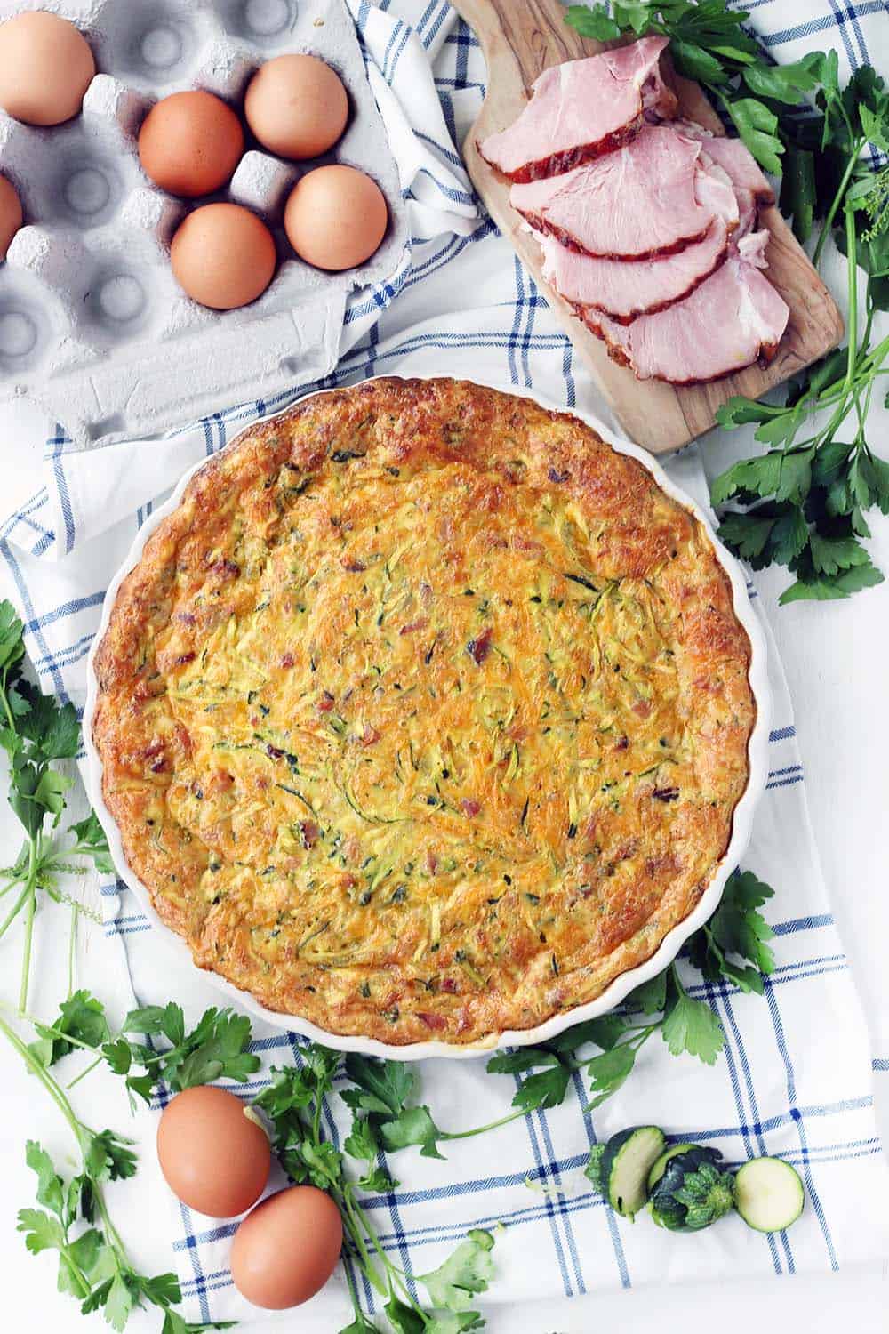 This crustless ham and zucchini quiche recipe is a great way to use up leftover ham  and feed a crowd easily! It can be served at room temperature so you can easily make it ahead of time.