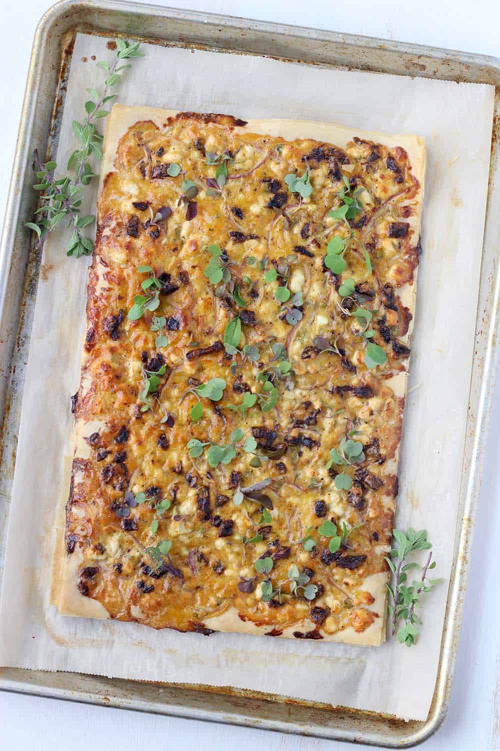 This Feta and Sun Dried Tomato Tart recipe is the perfect vegetarian appetizer or light meal. It's easy to make using filo (phyllo) dough, or even puff pastry. 