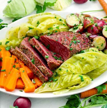Celebrate St. Patrick's day with this recipe for Instant Pot Corned Beef with Cabbage, Carrots, and Buttered Potatoes! It takes half the amount of time as on the stovetop when you use a pressure cooker. The best part is the potatoes, smothered in melted butter and fresh parsley, and the corned beef is perfectly cooked to a fall-apart texture. 