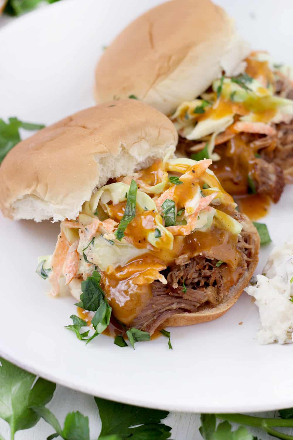 This Instant Pot Pulled Pork is a quick and easy recipe to feed a crowd! I love it served on slider buns with coleslaw or on tortillas with cilantro and onion. It's inexpensive, and the leftovers freeze beautifully.