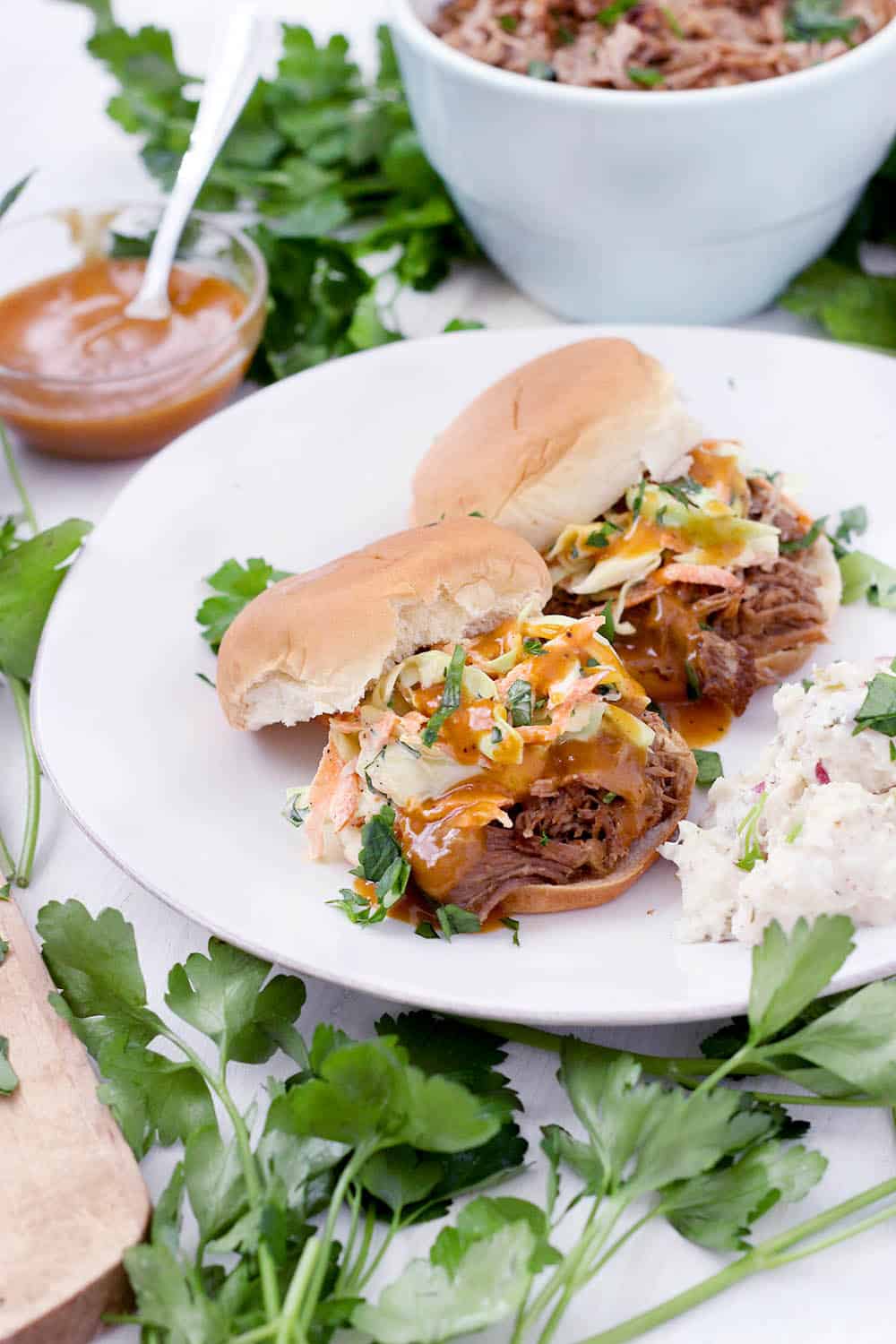 This Instant Pot Pulled Pork is a quick and easy recipe to feed a crowd! I love it served on slider buns with coleslaw or on tortillas with cilantro and onion. It's inexpensive, and the leftovers freeze beautifully.