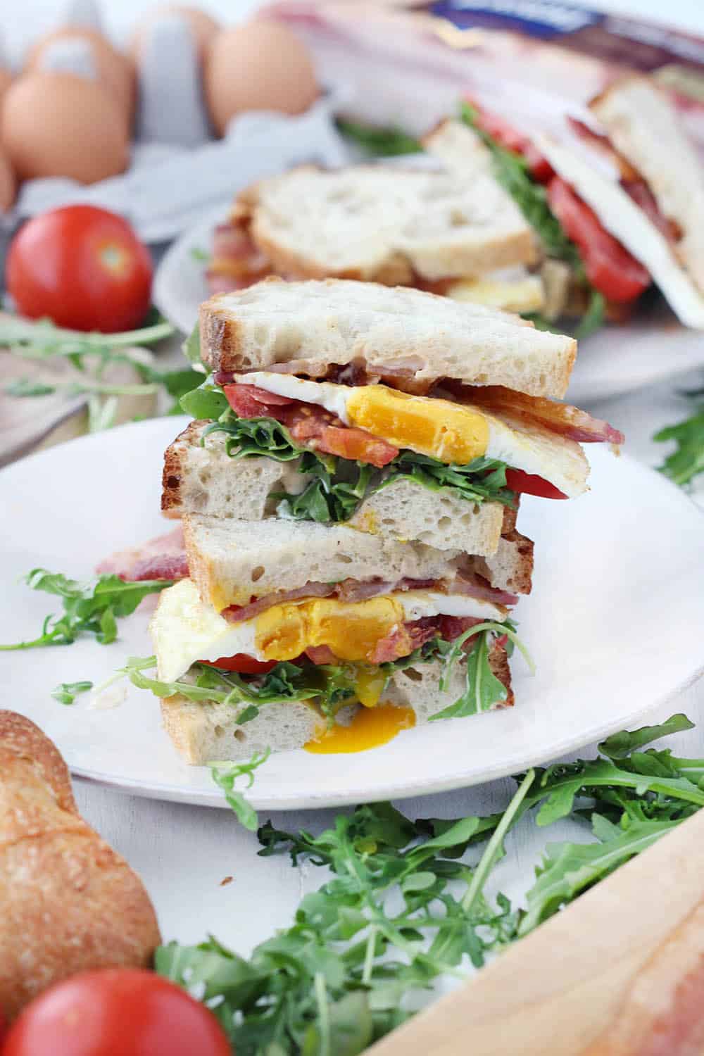 These Breakfast BLTs with Spicy Mayo and Arugula are piled high with thick-cut bacon and a perfectly fried egg! Bake the bacon in the oven to easily make these for a crowd.