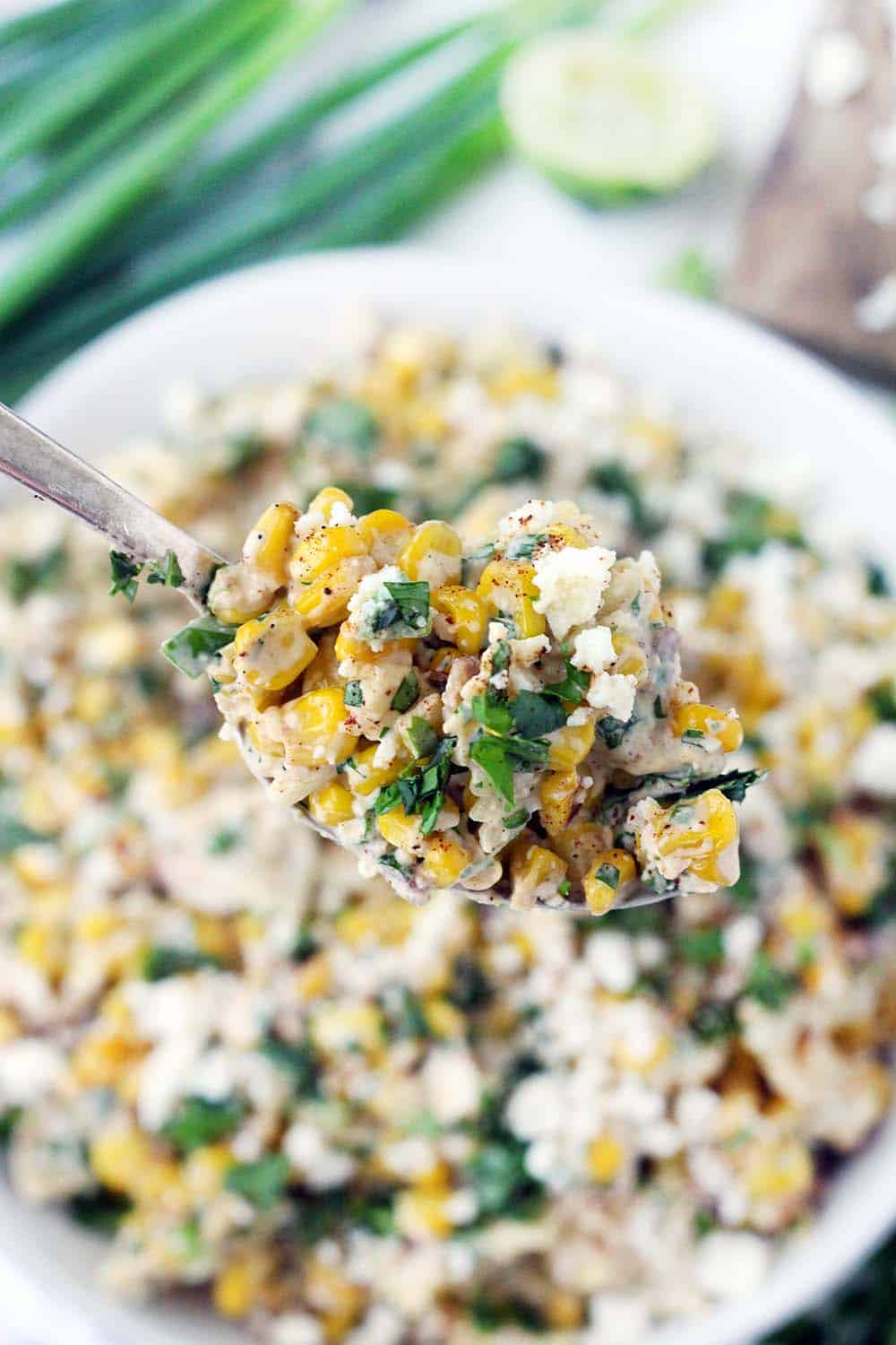 This Mexican Street Corn Pasta Salad is PACKED with sweet corn and tossed in a creamy chili lime dressing. With plenty of queso fresco, bacon, jalapeño, and green onions, this flavor-packed recipe is perfect for a potluck! Can be made with frozen, fresh, or canned corn. Plus, no grilling required! For extra smoky and charred flavor without grilling, the corn is sautéed in bacon fat.