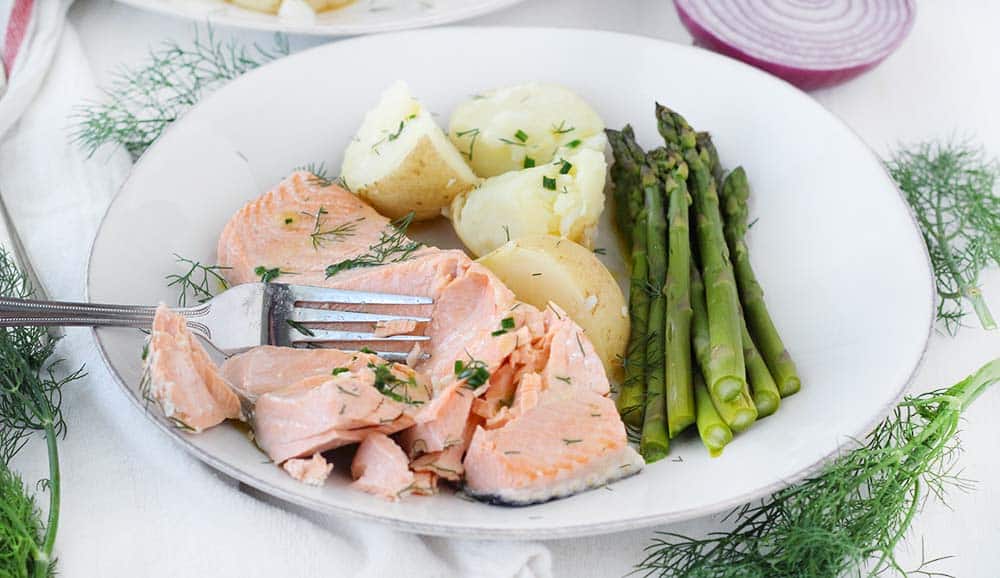 This poached salmon recipe comes out perfectly moist and flaky every time! It's drizzled in a delicious chive butter, takes only 15 minutes, and is a perfect low-carb, keto recipe.