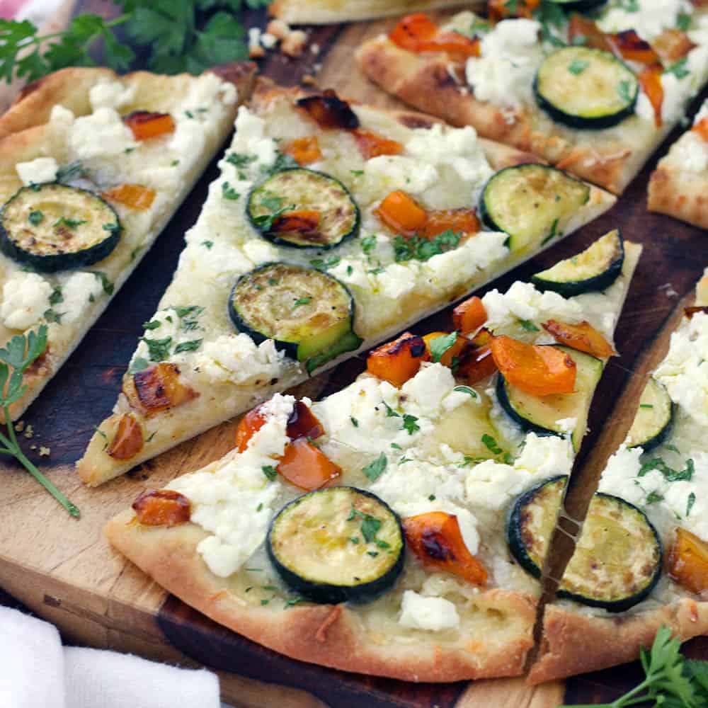 This vegetarian Sautéed Vegetable and Goat Cheese Naan Pizza recipe comes together in only 20 minutes for an easy weeknight dinner! Tip: place the baking rack in the lower half of the oven for a crisp crust.