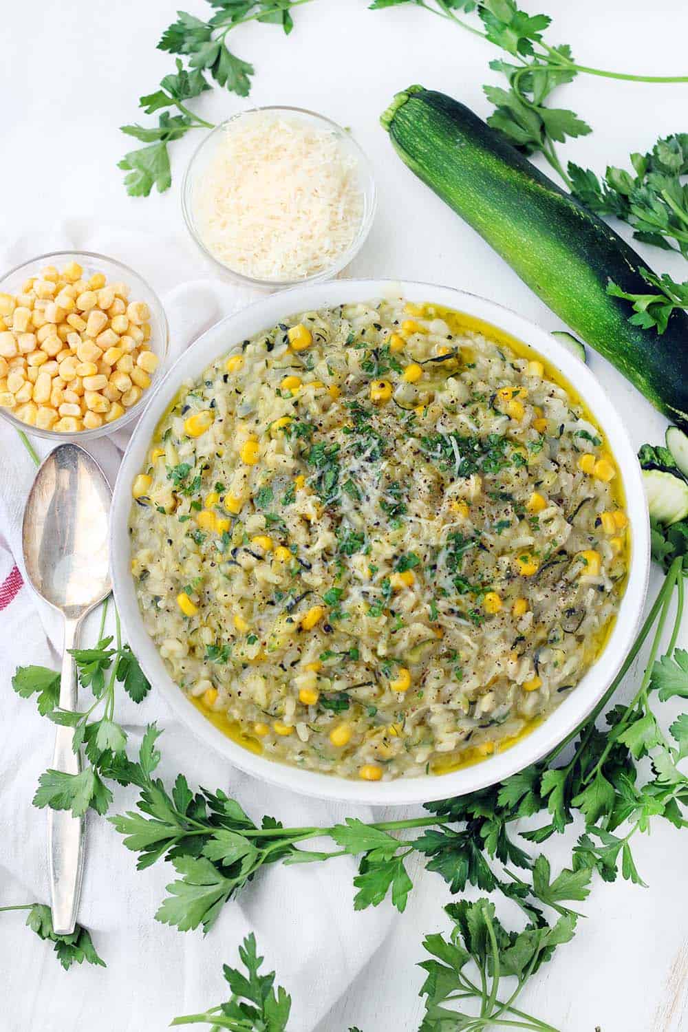 This vegetarian sweet corn and zucchini risotto recipe is such a great way to enjoy summertime vegetables! The zucchini is grated, so it melts into every bite while still maintaining a great texture, and the corn cobs are used to add flavor and starch to the broth base. The leftovers are great for brunch served with a fried egg on top.