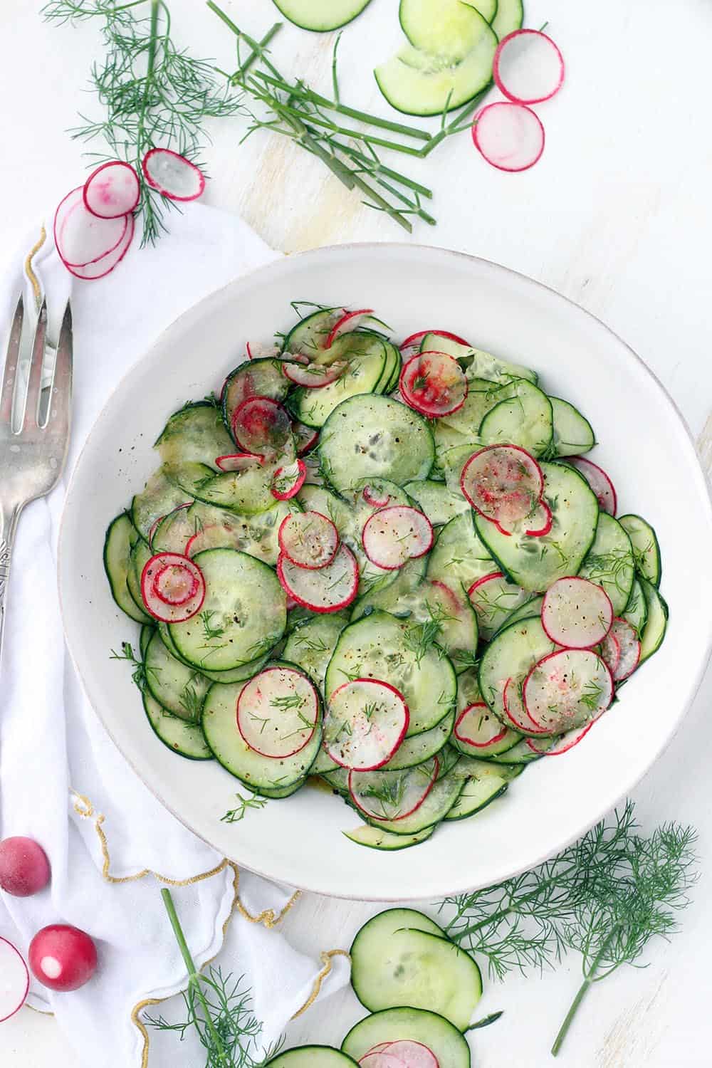 This Cucumber and Radish Salad with Dill is dressed in a sweet and tangy red wine vinaigrette and is addicting! A perfect low-carb, refreshing side that can easily be made ahead of time. 