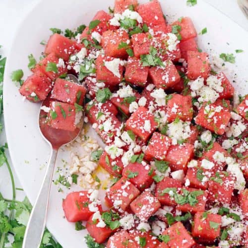 This refreshing watermelon salad with queso fresco, lime, and cilantro is the perfect balance of sweet and salty! It's easy to make this vegetarian side dish in advance and perfect for your summer festivities.