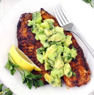 This super flavorful Blackened Tilapia comes together in less than 10 minutes!! Topped with a cool and refreshing avocado cucumber salsa, this is the perfect quick and easy low-carb recipe. Paleo, gluten free, and whole30 compliant.