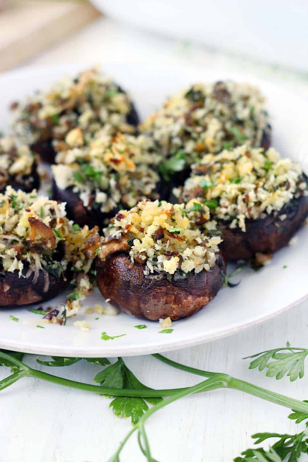 These Italian Vegetarian Stuffed Mushrooms are a great make-ahead recipe for dinner or an appetizer! They're packed with flavor from the fresh herbs, shallots, garlic, and parmesan cheese. 