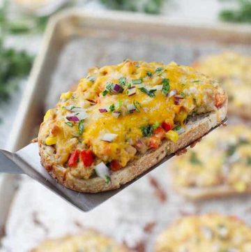 Tex Mex Tuna Melts are such a fun twist on a classic! Corn, bell peppers, jalapeño, cilantro, and onion are mixed in tuna, spread on bread, and topped with Mexican cheese, then baked until melty. Such an easy weeknight dinner recipe!