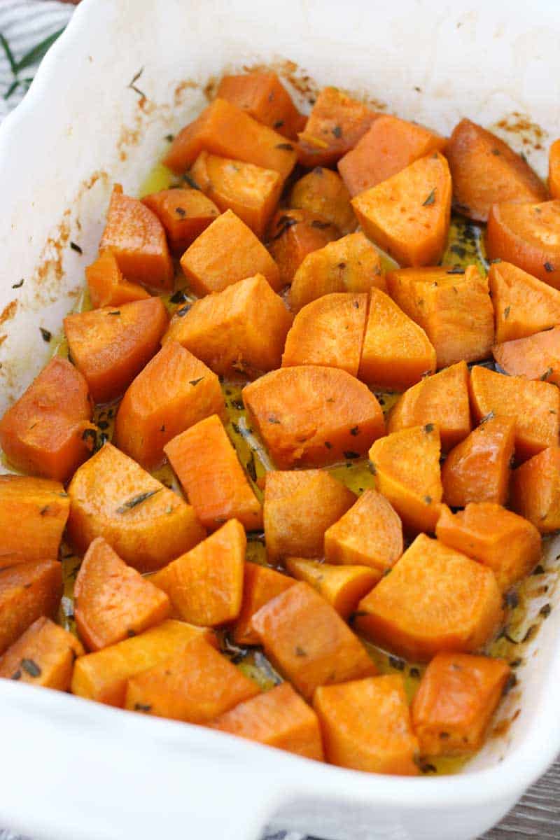 These Glazed Sweet Potatoes are coated in a mixture of melted butter, fresh rosemary, and maple syrup, then baked in the oven until super tender. They're not too sweet, and they're the perfect vegetarian, gluten-free side dish!