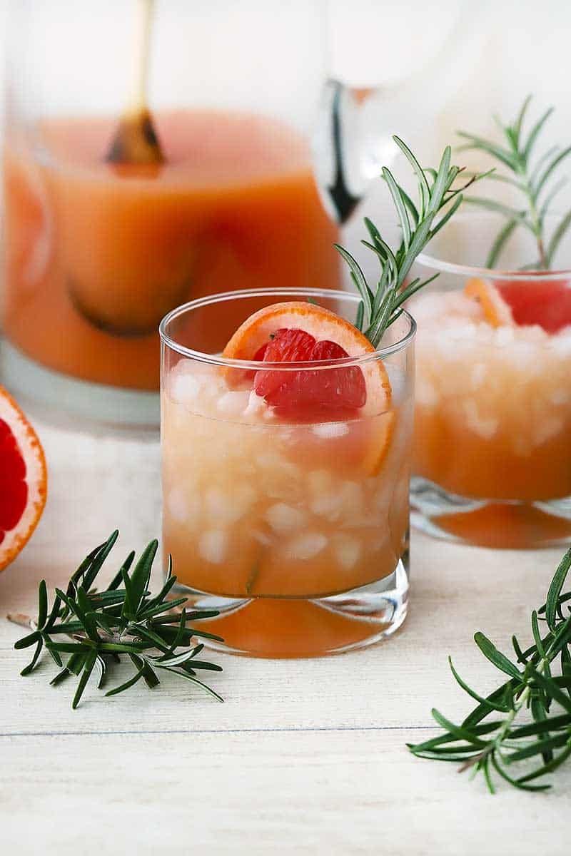 These Rosemary Greyhound Cocktails are made in batch, so they're easy to mix in advance for a party. This recipe uses grapefruit juice, vodka, and rosemary simple syrup- you can use seltzer for a virgin alternative.