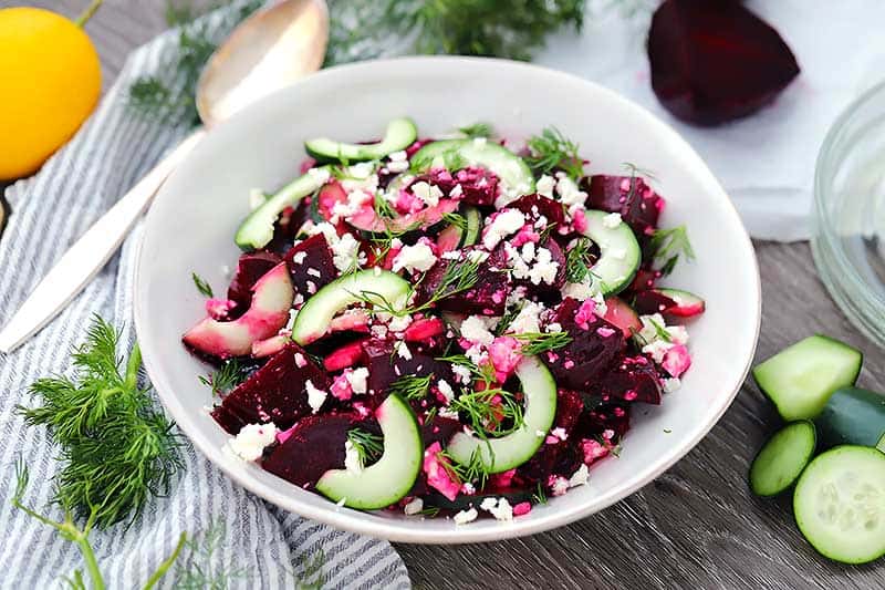 Horizontal photo of a beet salad in a white bowl.