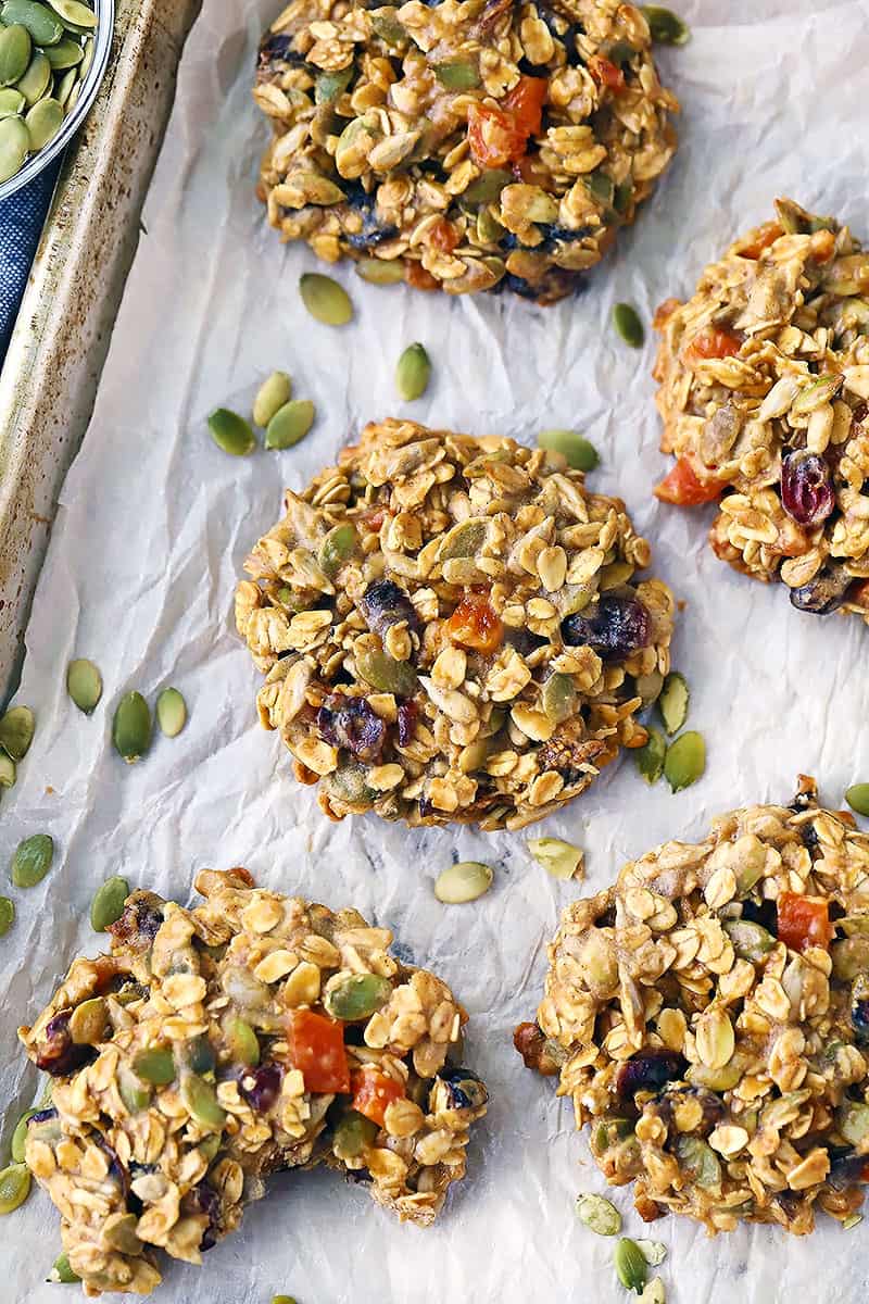 Overhead photo of breakfast cookies with pumpkin seeds scattered around.