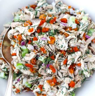 Apricot Dill Chicken Salad with Sunflower Seeds in a bowl with a spoon.
