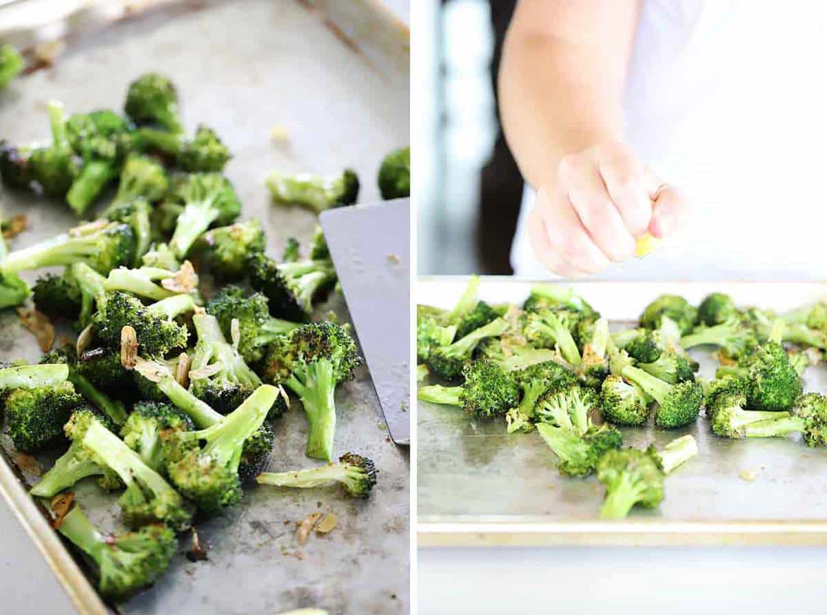 Roasted broccoli with garlic on a rimmed baking sheet and squeezing fresh lemon juice over it.