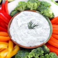 Square photo of dill dip and veggies.