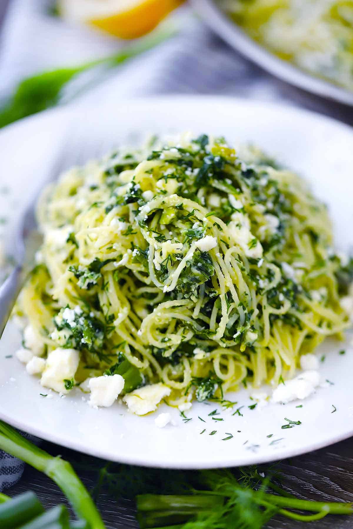 spinach and feta spanakopita pasta on a white plate.