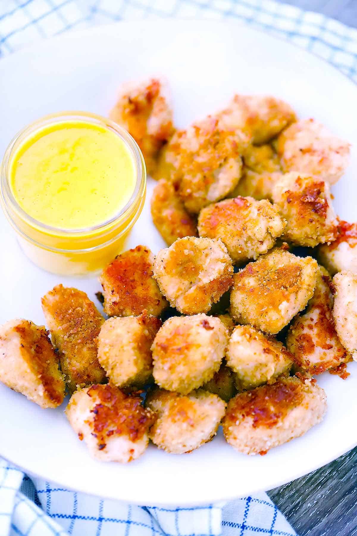 A plate of homemade chicken nuggets and honey mustard sauce.