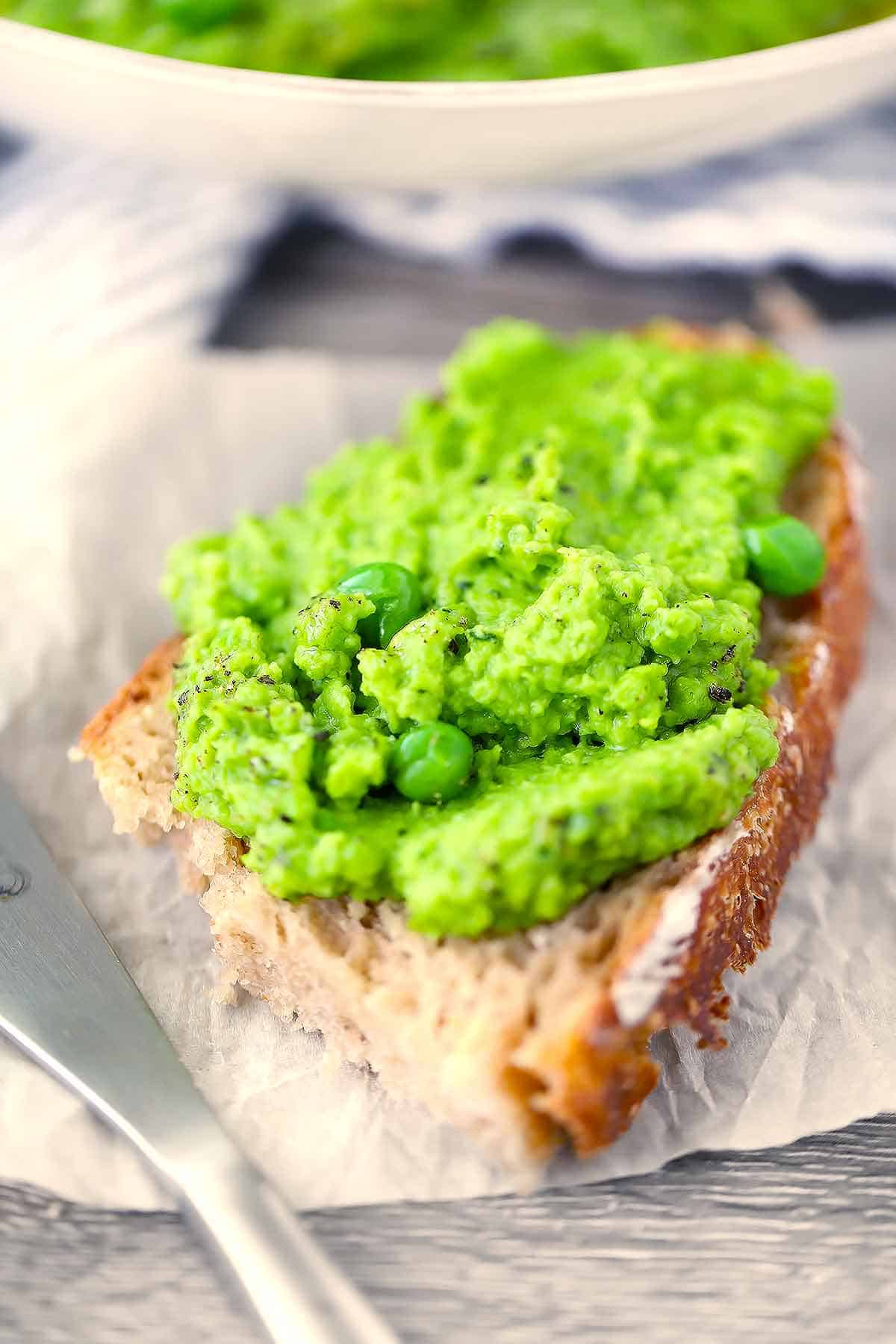 Pea hummus spread on sourdough bread.