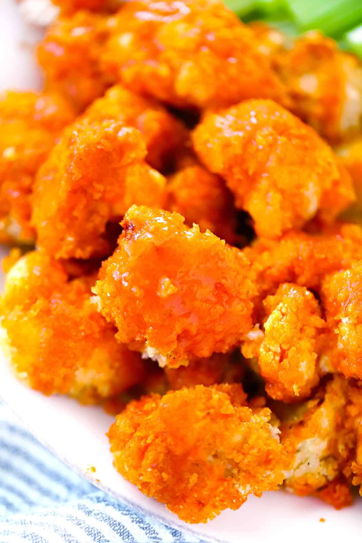 Close up photo showing the texture of crispy baked buffalo cauliflower wings.