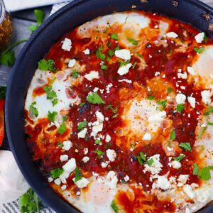 Square photo of shakshuka in a skillet.