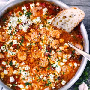 Square photo of greek shrimp with feta and tomatoes.