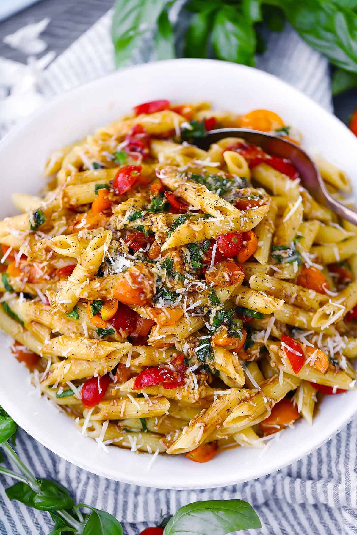 Close up photo of bruschetta pasta with tomatoes and basil.