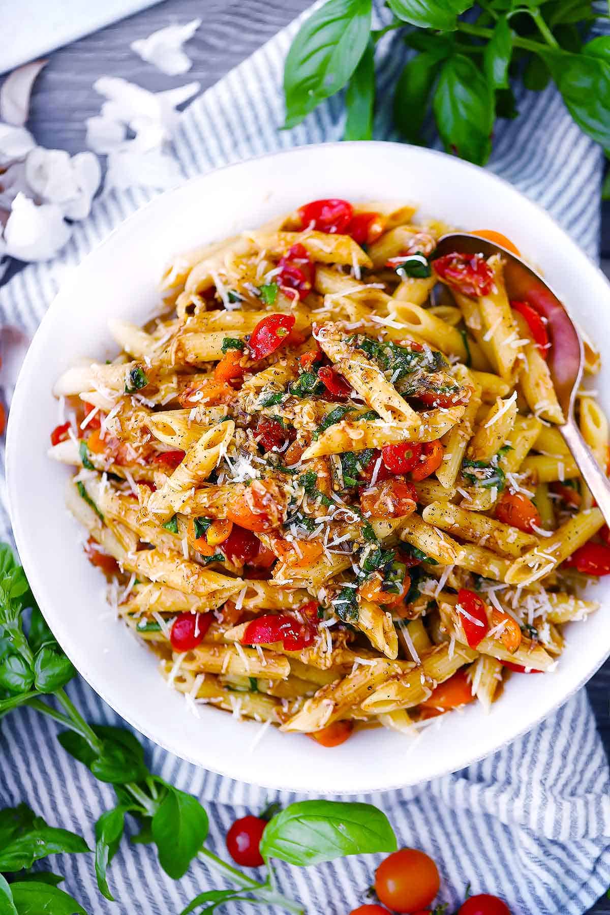 Overhead photo of bruschetta pasta in a white bowl.