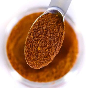 Square photo of a spoonful of pumpkin pie spice mix.
