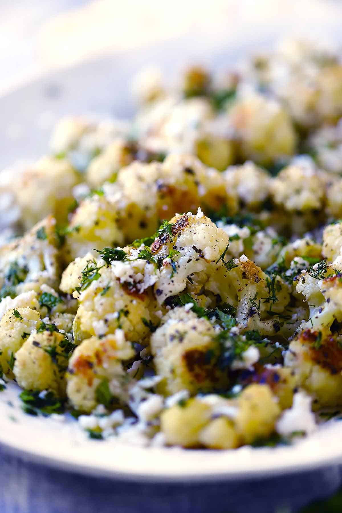 Close up photo of Greek roasted cauliflower with garlic and herbs.