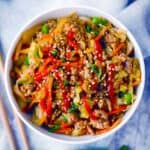 Square photo of egg roll in a bowl.