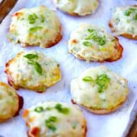 Square photo of English Muffin tuna melts on a baking sheet.