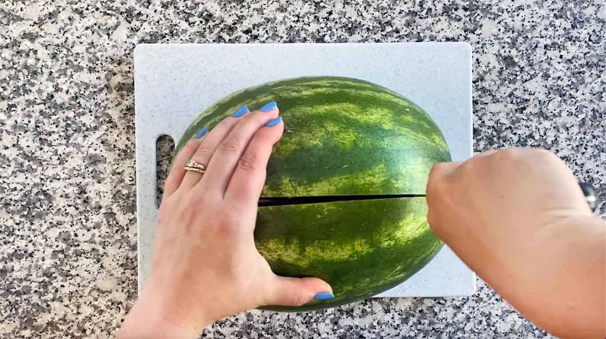 Cutting a watermelon in half.