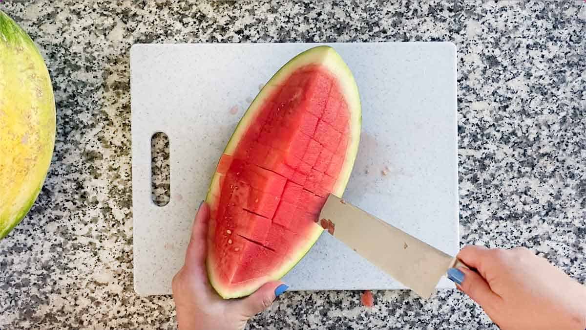 Slicing a watermelon along the rind.