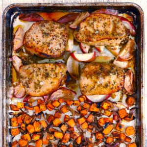 Square photo of sheet pan pork chops with apples and sweet potatoes.