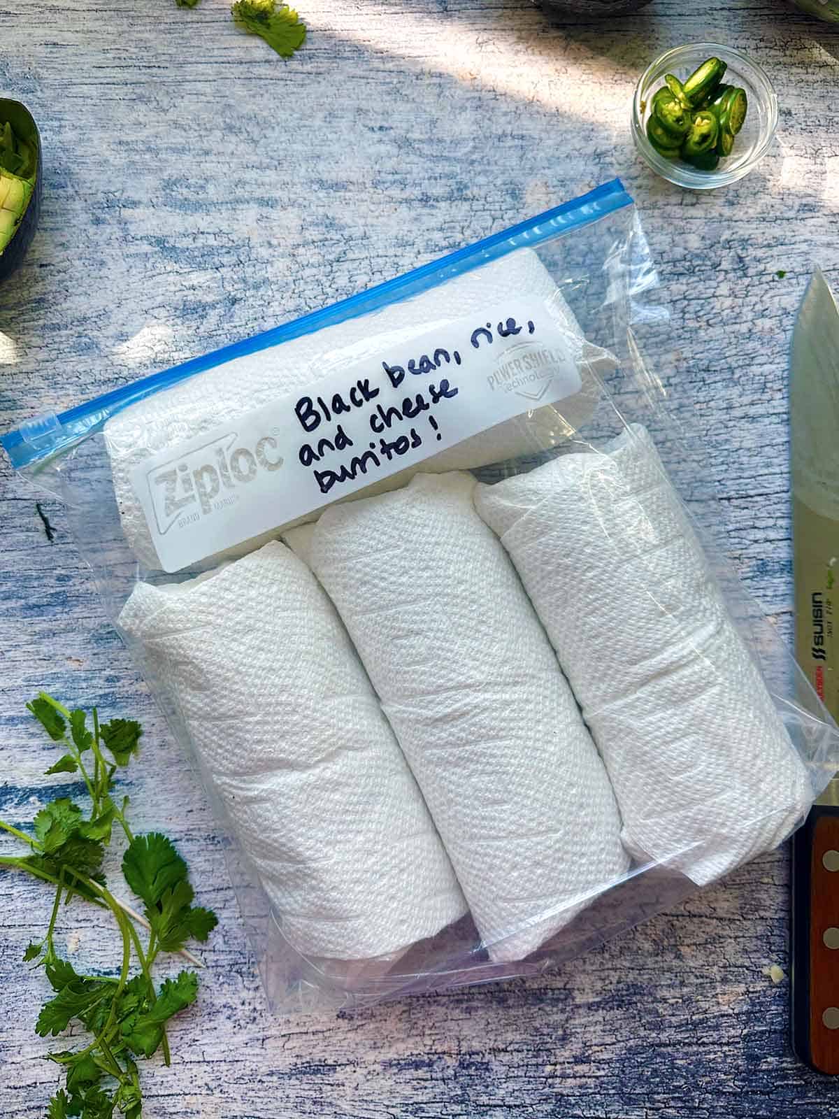 A zip top bag with burritos in it for the freezer.