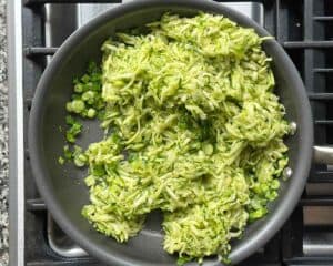 Green onions and grated zucchini in a nonstick skillet.