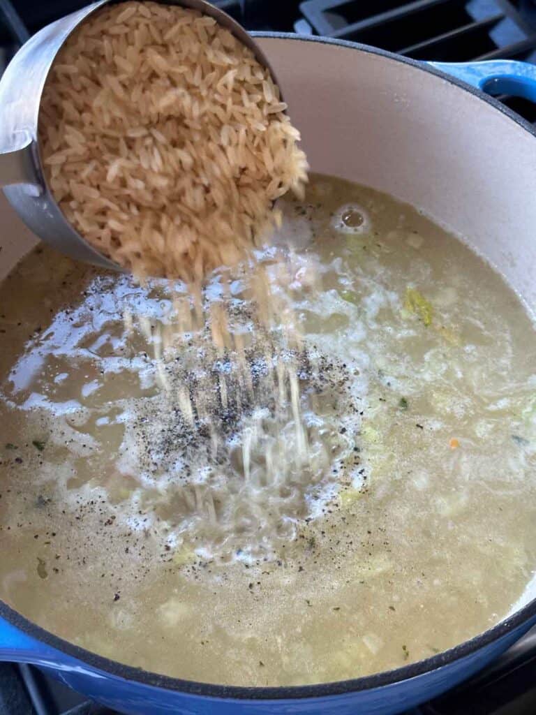 Adding rice to soup.