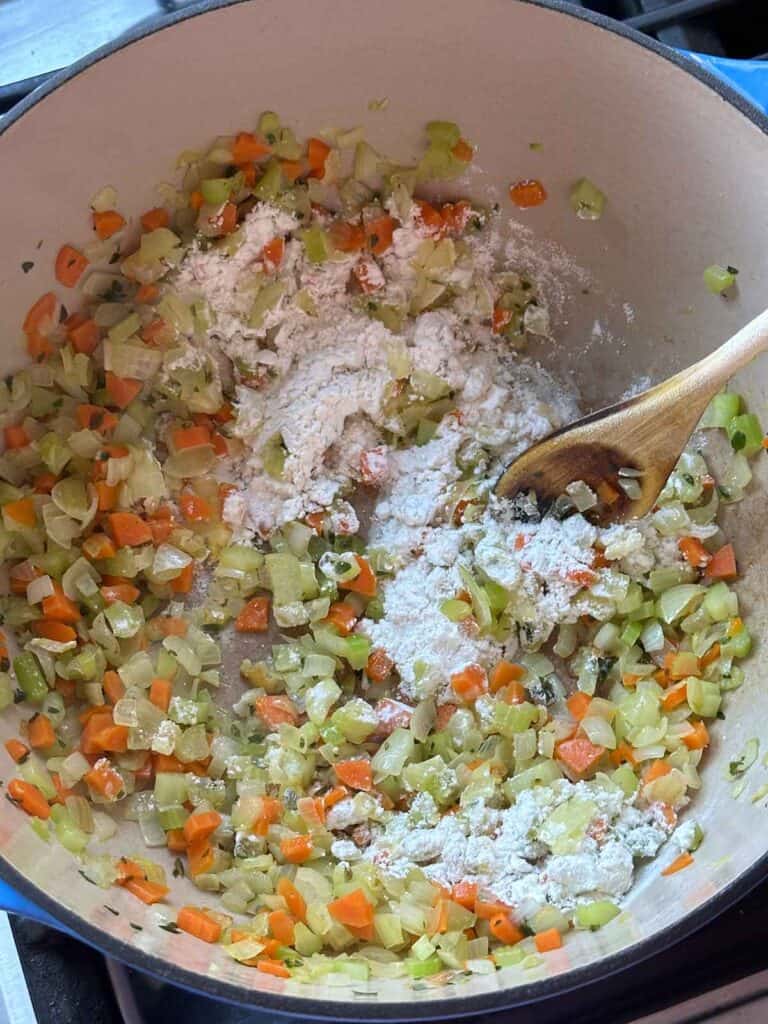 Stirring veggies and flour together for soup.