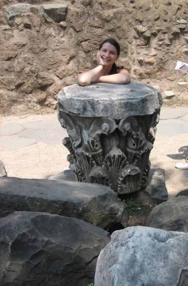 Elizabeth Lindemann in Italy when she was in Architecture school, leaning on a column capital in Pompeii.